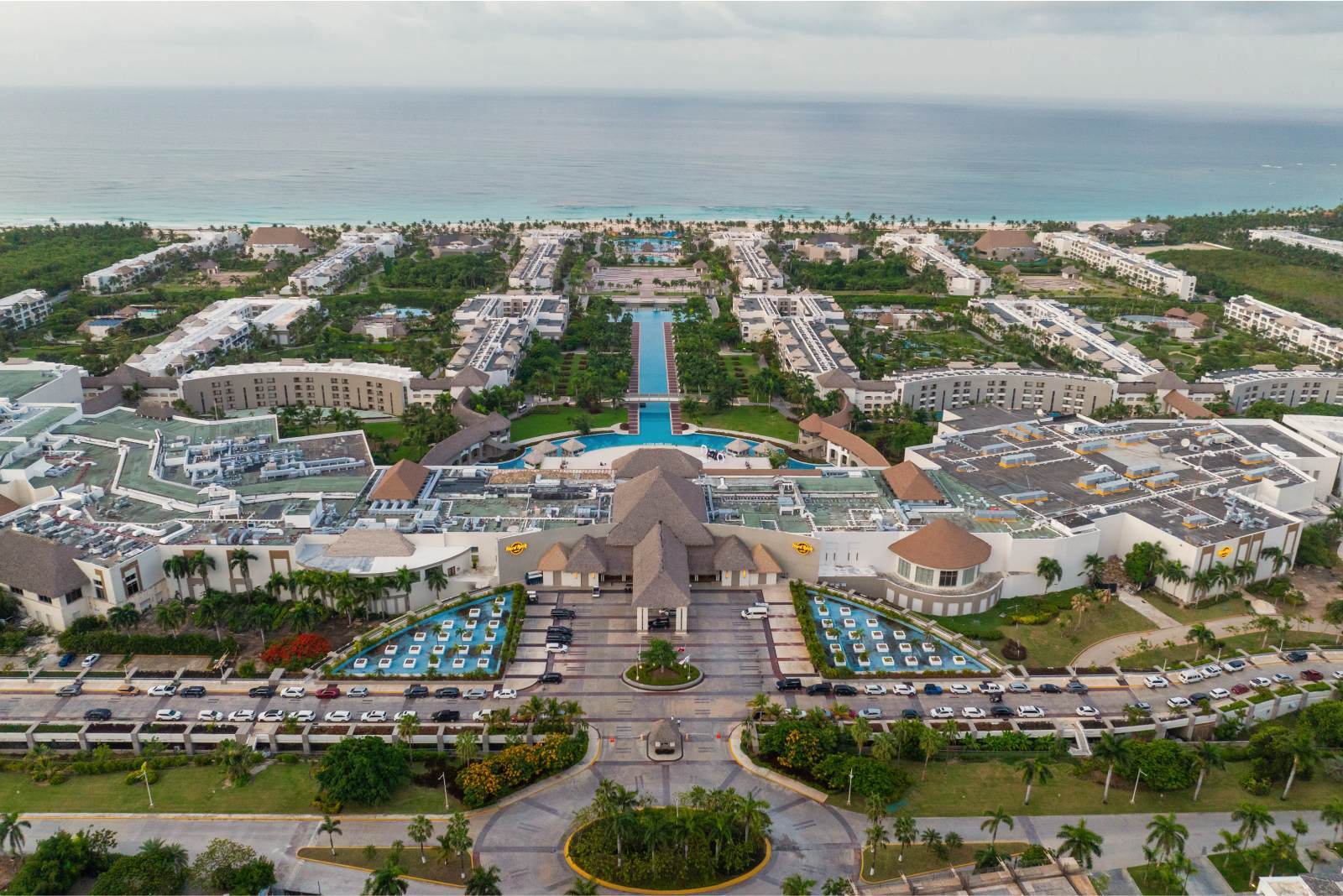 Aerial view of Hard Rock Hotel and Casino Punta Cana, its pools, tropical grounds and beachfront