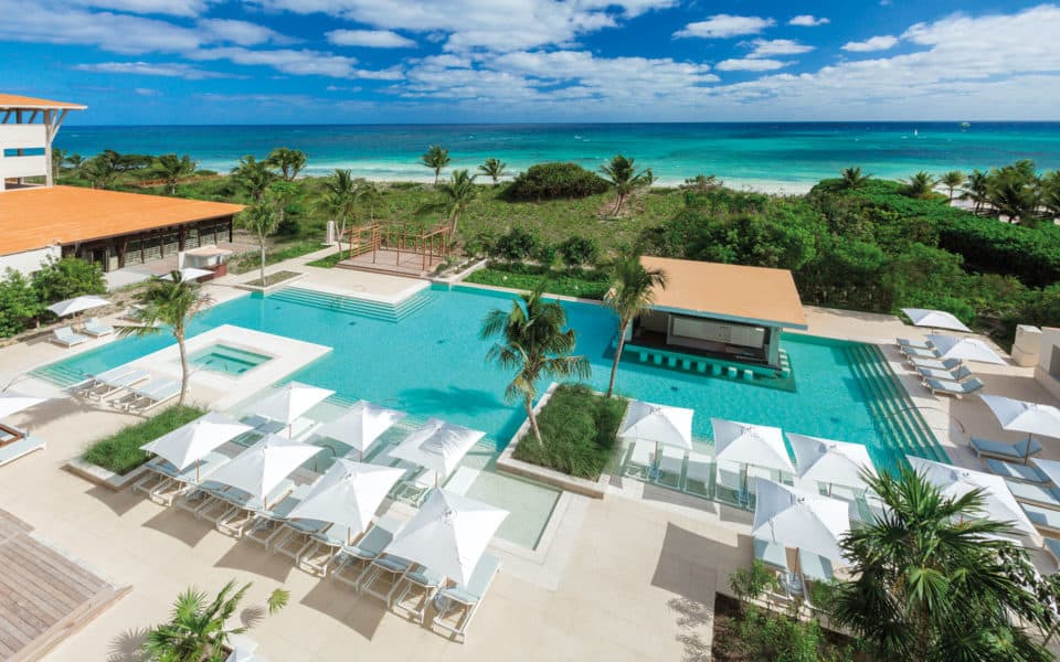 Aerial view of the Escondida pool, palms and Caribbean coastline at UNICO 20°87° Riviera Maya